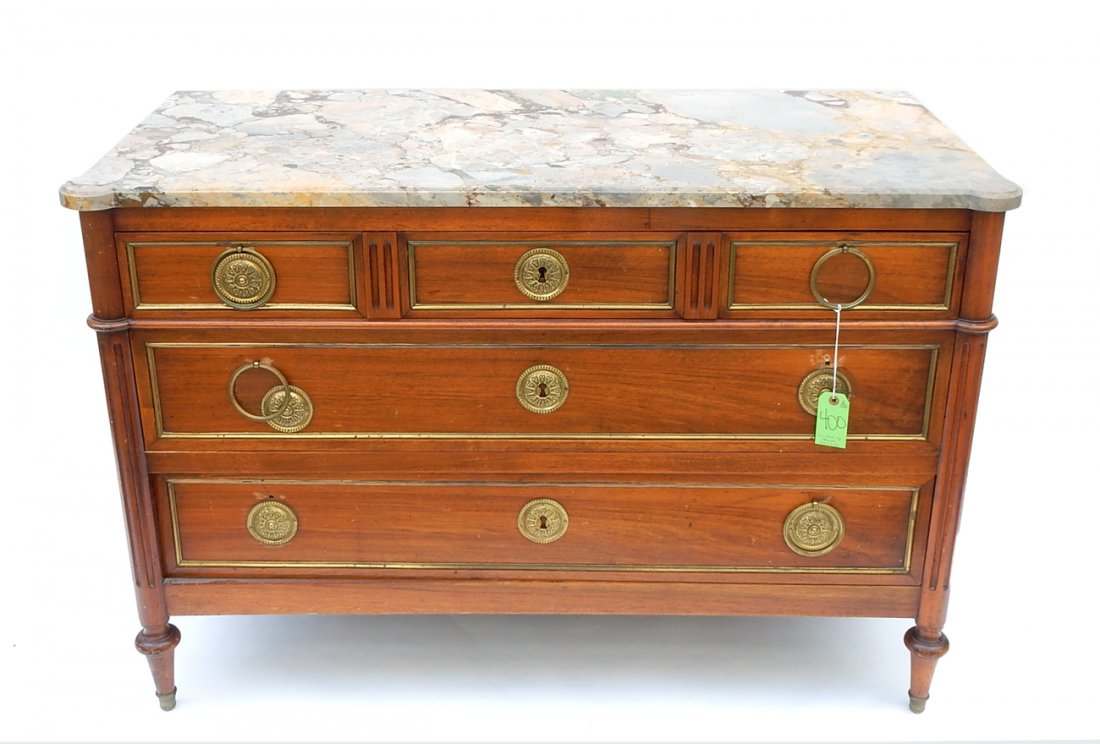 Louis XVI-Style Marble Top Commode: 3-drawer marble top commode with brass drawer front trim and sunburst pulls. [49 5/8" W x 22 1/8" D x 33 3/4" H]. Pulls loose with some detached elements (all present).