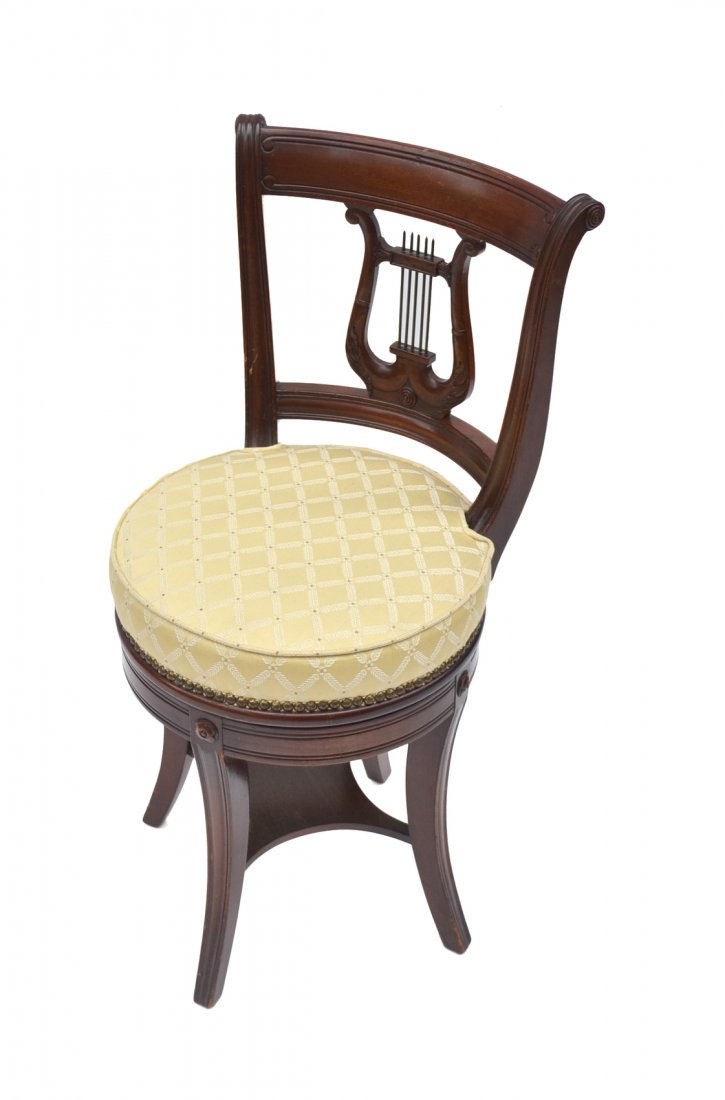 Lyre-Back Swivel Piano Stool: Mahogany swivel piano stool with upholstered seat and carved lyre motif backsplat. [15" W x 13" D x 31" H]. In overall good condition.