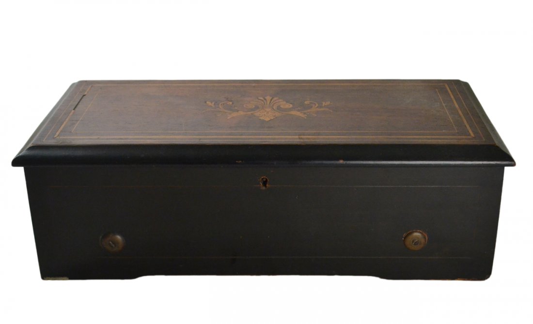 Antique Swiss Music Box: Bears inlaid case with original paper label affixed under lid inscribed "8 Airs 7 1/2 / 1616" with song list below. Working condition with winding crank. [16 3/4" W x 7" D x 5 3/8" H]. Case bears wear