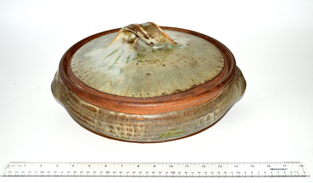 Karen Karnes Stoneware Casserole Dish: Stoneware covered casserole dish having a grey and green glaze, strap handles, and lid. [14 1/2" Dia x 6" H].