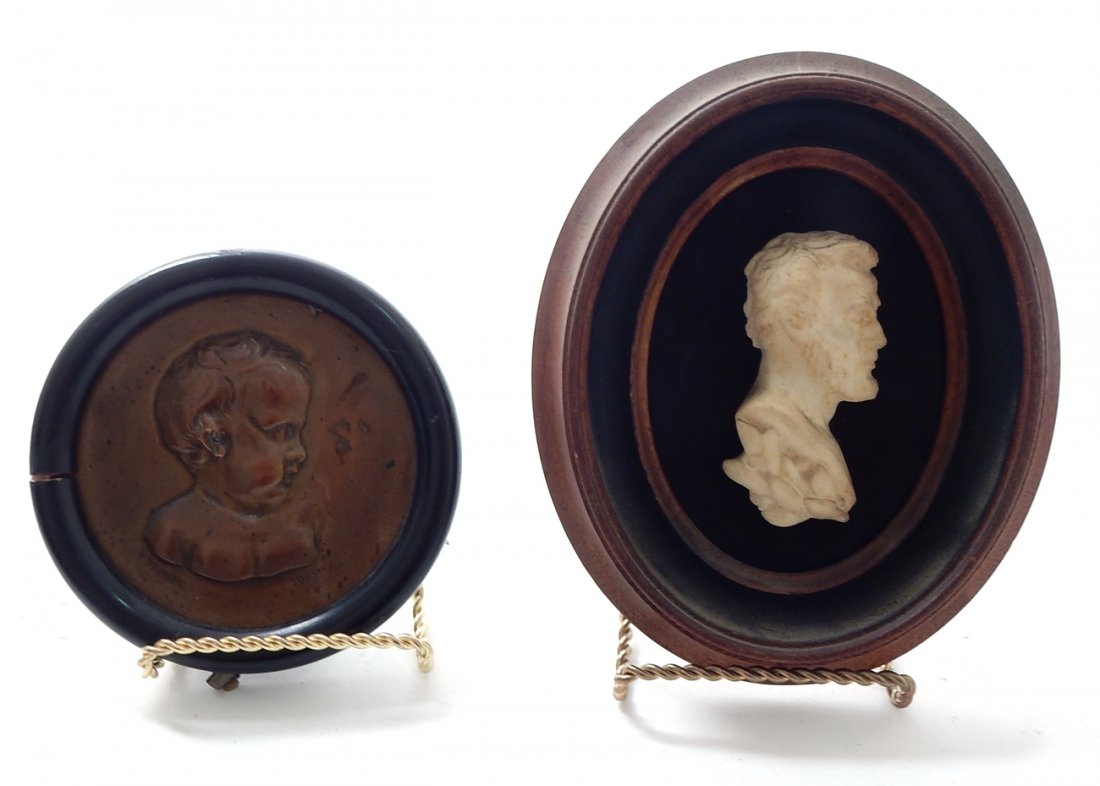 Two Miniature Framed Portraits: Comprises: 1.) Portrait of Lincoln. Sandstone in mahogany frame. 2.) Bronze portrait of a child. Signed "R. Deaman, 1909". Wood frame. [4" dia]. Good condition.
