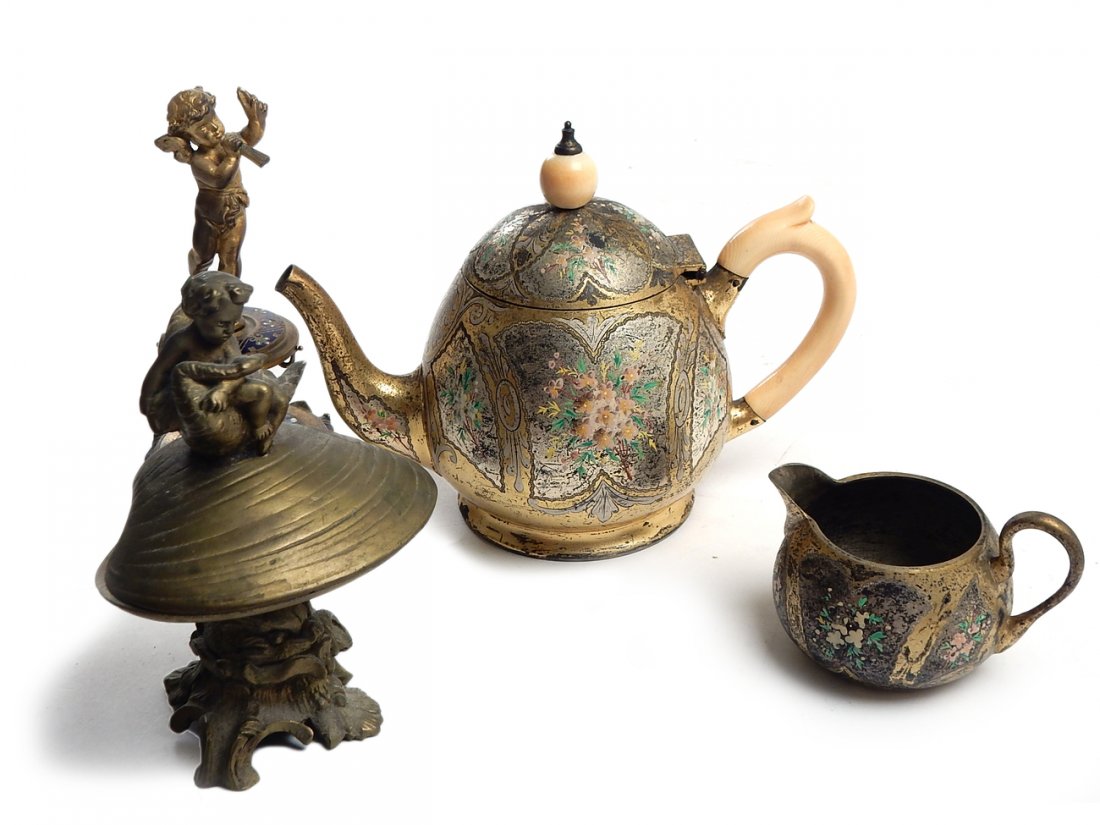 Four Decorative Items: Comprises: A small teapot and pitcher, a brass footed shell with a cherub and swan, and a figural cherub on an enameled base (piece broken off). All sold together "as is".