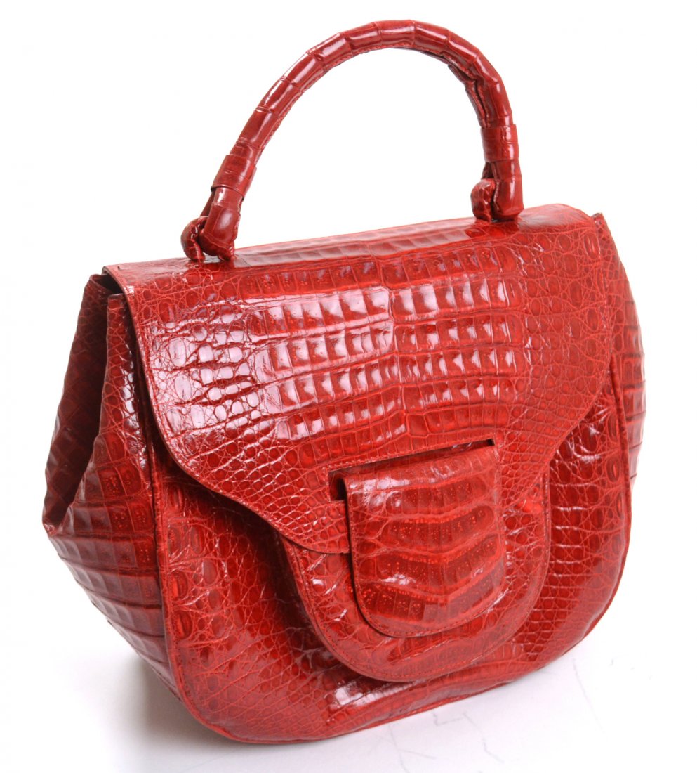 Nancy Gonzales Crocodile Pocketbook: Shiny red leather with magnetic strap guard. Logo found in interior. Colombian crocodile leather. [10 1/2" x 5 1/2" x 9 3/4"]. Good condition.
