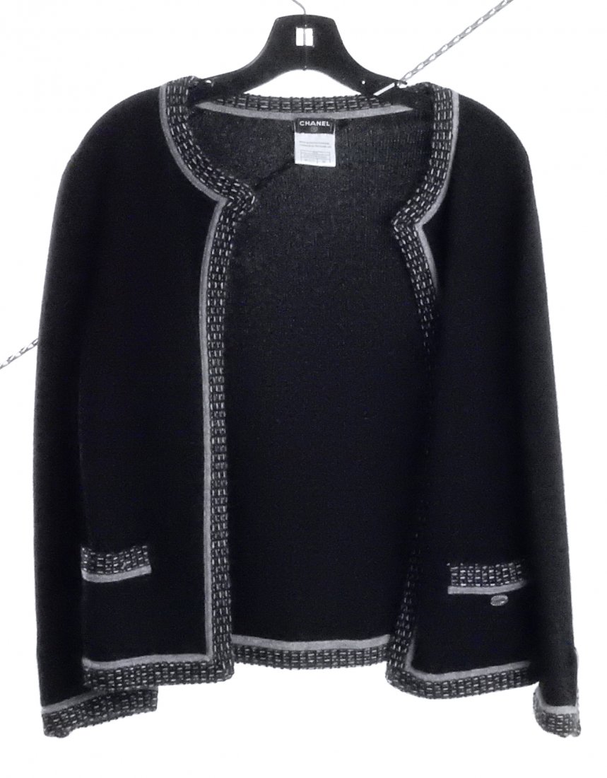 Chanel Cashmere Sweater: Black with gray/black trim around neck and down the center. 100% cashmere. Size 38 (Euro). Good condition.