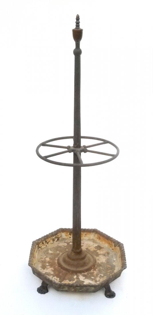Iron and Brass Umbrella Stand: Iron and brass umbrella stand with brass finial. [14 1/2" Dia x 20" Dia base]. Worn, with paint loss and damaged finial.
