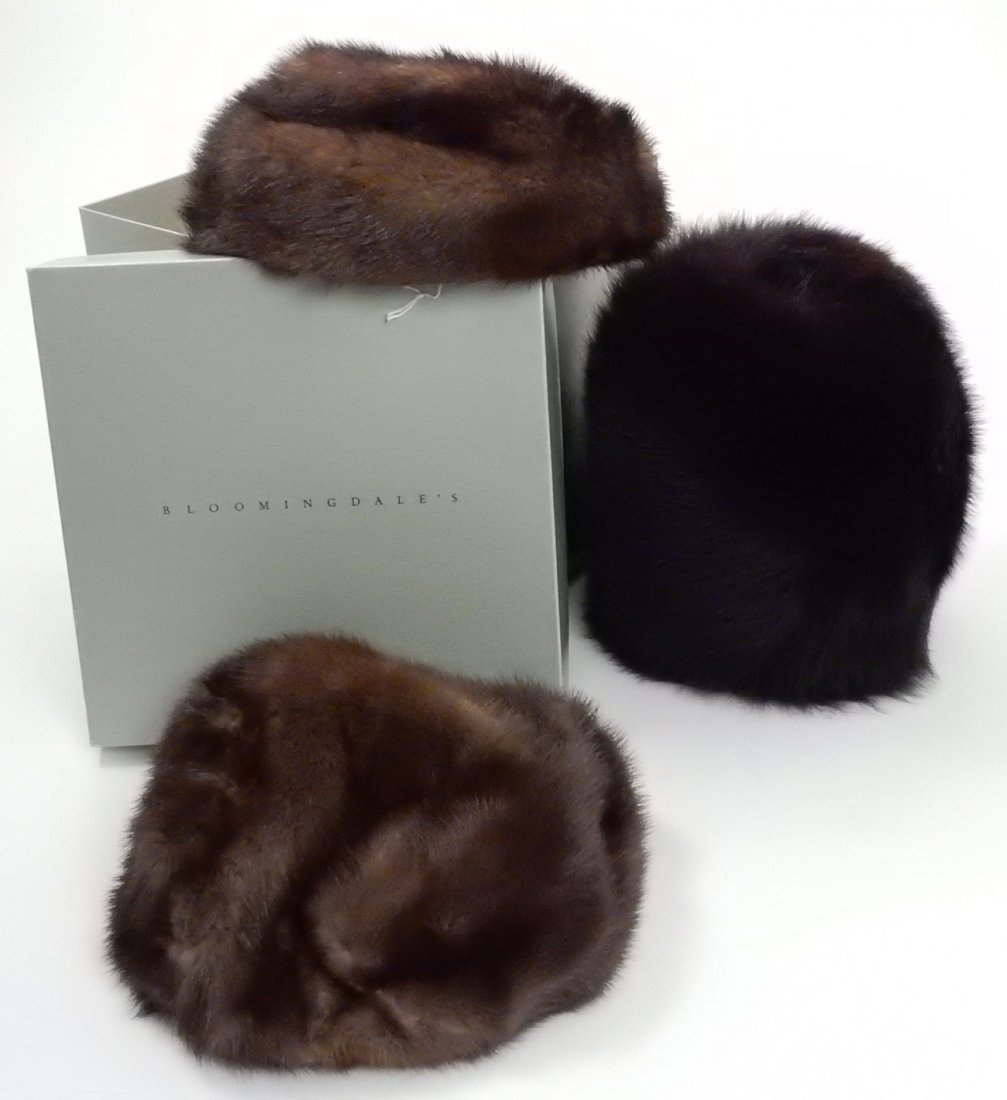 Two Mink Ladies Hats, One Fox Muff: Two brown mink hats, one bearing "Linda" mark, the other unmarked. Accompanied by one fox muff, brown with red/purple hue. All contained in box.