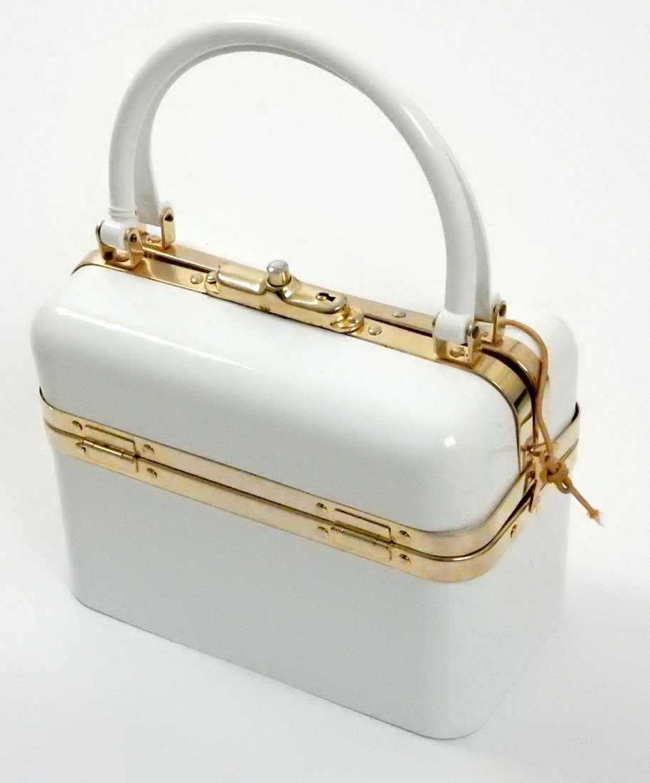 Enamel Purse, Two Christopher Ross Belts: White enamel purse with gold trim marked "Made in France". Accompanied by two pink belts with large gold rabbit belt buckles.