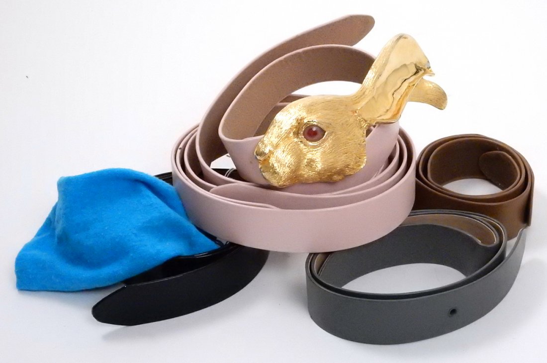 Six Christopher Ross Belts, 1 Belt Buckle: 1 black, 2 pin, 2 gray, 1 brown belt. Large gold rabbit head belt buckle with pink eye.