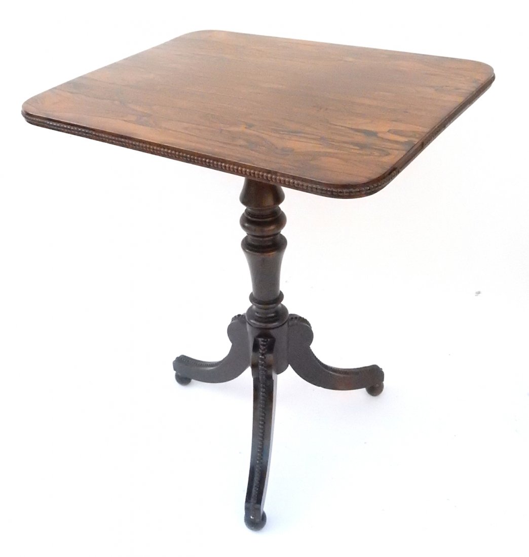 Three-Legged Exotic Wood Side Table: Exotic wood side table with walnut three-legged base with beading. [22 1/4" W x 18" D x 26 1/2" H]. Losses to beading along top, edge of table and feet.