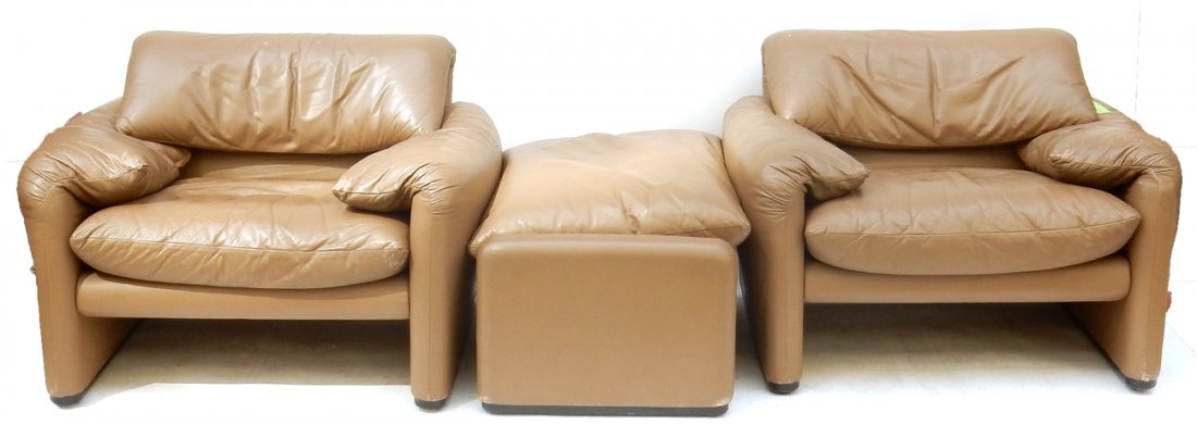 Pair of Maralunga Chairs and Ottoman: Brown leather maralunga arm chairs and ottoman from Cassina. Designed by Vico Magistretti. [Chairs: 40" W x 32" D x 28" H (17" H to seat); Ottoman: 34 1/2" W x 24" D x 18" H]. Scuffs and wear.
