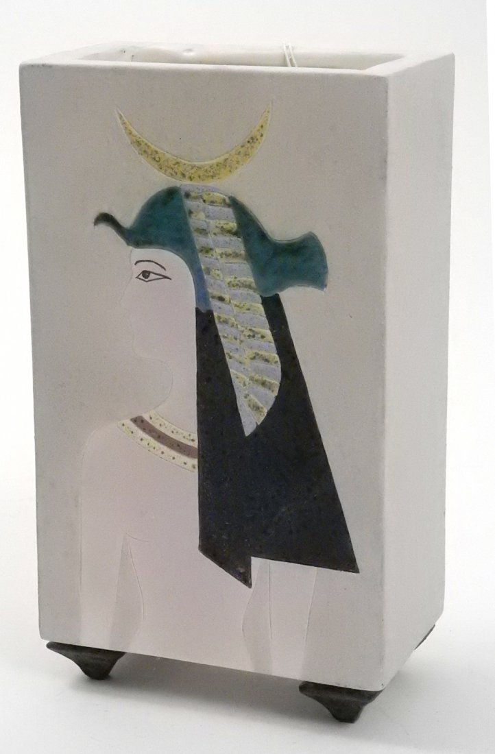 Memphis-Style Ceramic Vase: Rectangular vase with ancient Egyptian inspired goddess figure on one side. Signed illegibly on bottom. [5 7/8" W x 3 1/2" D x 10 1/4" H]. Some scuffs.