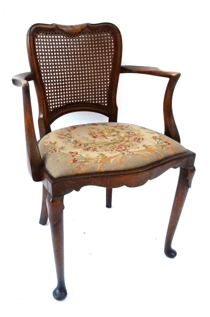Cane Back Walnut Armchair with Pad Feet: Cane back armchair. Walnut with pad feet. Needlepoint seat with standing figure. [22 1/4" W x 18" D x 33 3/4" H]. Good condition.