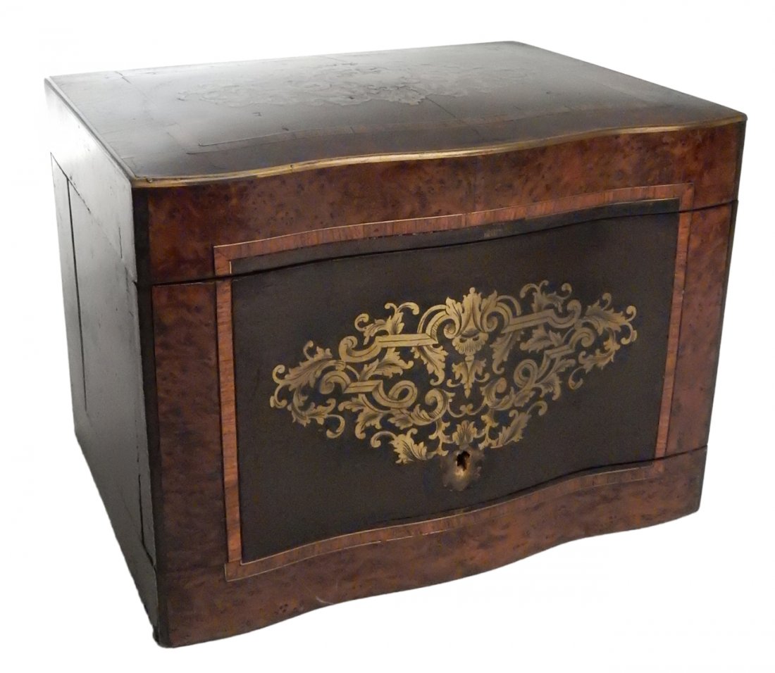 Antique Tantalus Container: Hinged front box with brass trim, birds eye maple, kingswood, and mahogany veneers. Features brass boucle work inlay on front and top. [13" W x 10" D x 9 3/4" H]. Missing escutcheon. Exhibits wear com