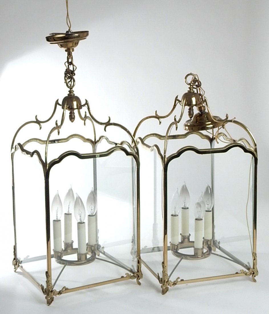 Pair of Brass and Glass Lanterns: Ceiling fixture lanterns, each bearing four candlestick form candelabra socket lights. [10 5/8" W x 10 5/8" D x 22 3/4" H].