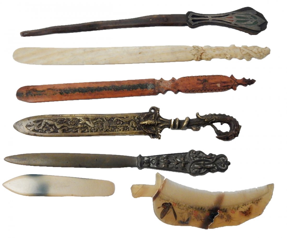 6 Decorative Letter Openers & Comb: Six decorative letter openers and Oriental comb. Materials include metal, bone, and wood. [Longest: 11 3/4" W x 3/4" D x 1 1/8" H]. Wear commensurate with age. From Martin Parker / Spencertown Art and