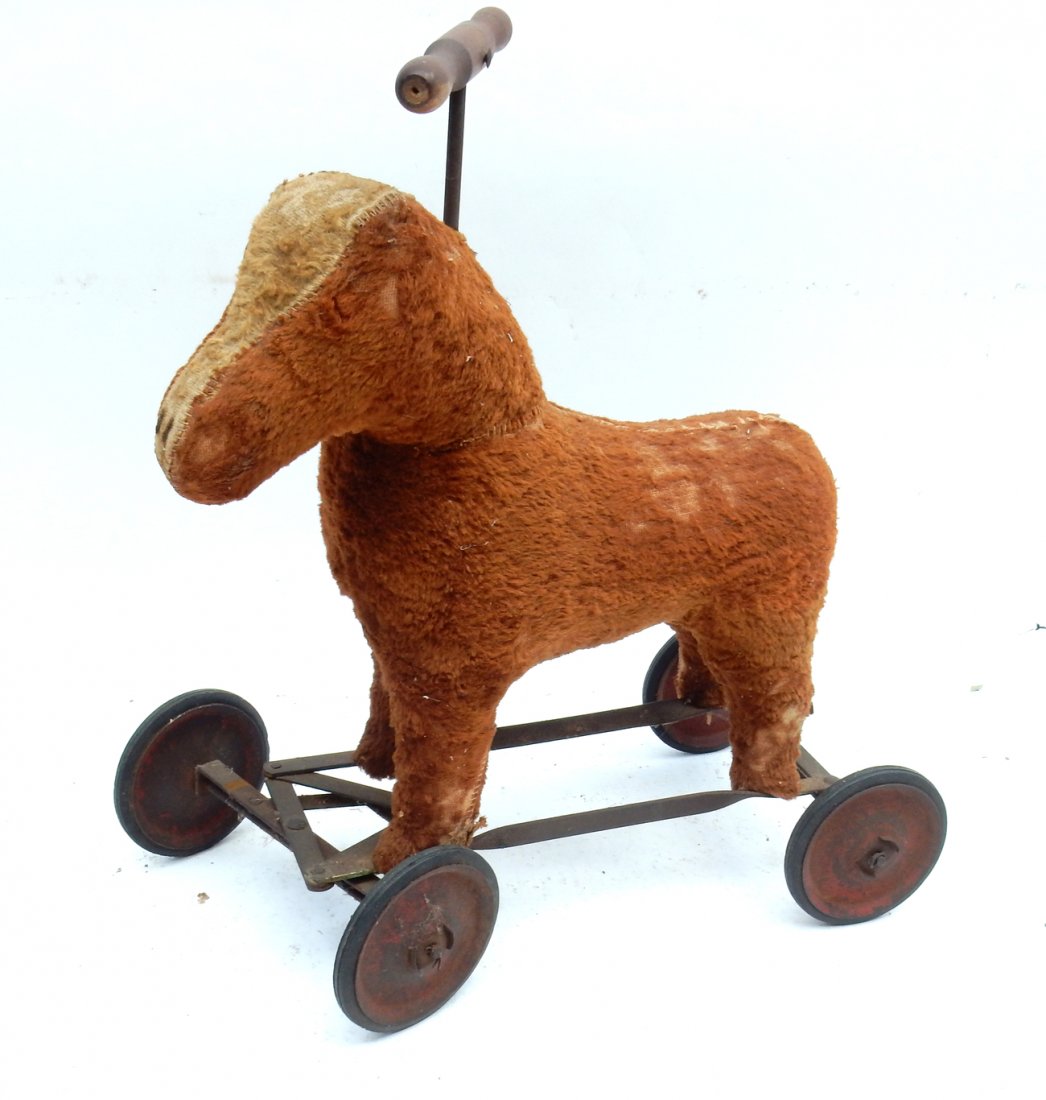 Vintage Toy Rolling Horse: Vintage toy rolling horse. [21" x 9 1/4" x 21"]. One eye missing, some loss of hair, aging to tires. From Martin Parker / Spencertown Art and Antique Company.
