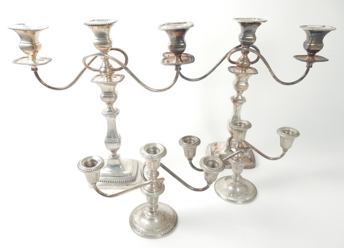 Two Pairs of Candelabra: Two candelabra, one weighted sterling and the other silver plate. Both three arm inserts, converted to candlesticks. [Silver plate: 14" W x 4" D x 14" H; Weighted sterling: 10 1/4" W x 3 3/4" D x 6 1/