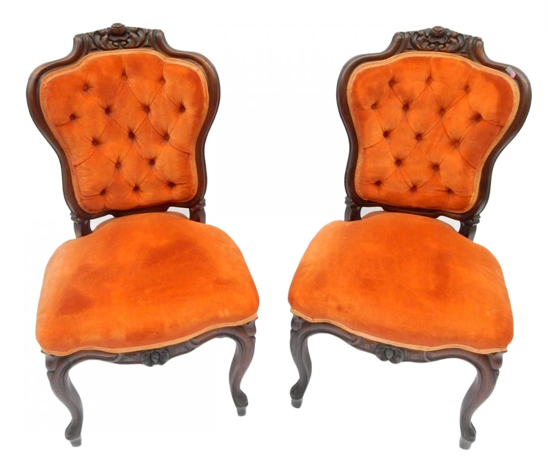 Two 19th Century Walnut Parlor Chairs: Upholstered, featuring floral wood design top center. [19 3/4" x 23" x 17 1/2" (to seat); 35" to top]. Light wear to upholstery, some soil spots. Overall good condition.