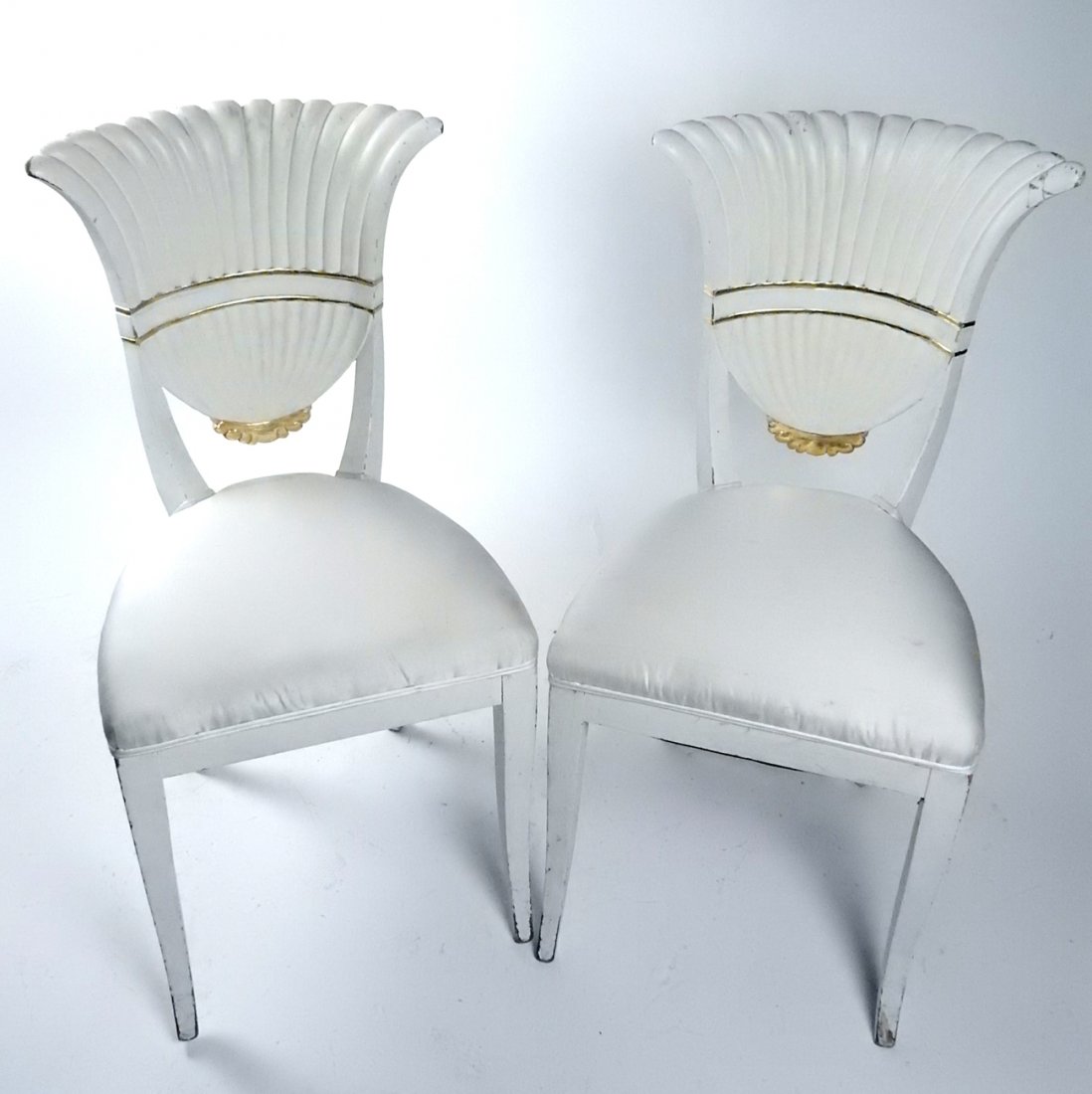Pair of White Fan-Back Side Chairs: In the manner of Serge Roche, a pair of white and gilt painted side chairs. [17 1/2" W x 35" H (backs) x 17" to seat]. Losses with wear.