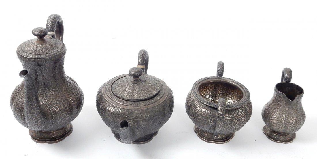 Victorian 4-Piece Tea Service: Victorian silver four-piece tea and coffee service by Hunt & Roskell, London 1871/2. Features Indian inspired decoration. [Coffee pot: 8" H]. Total combined weight: 66.4 dwt.
