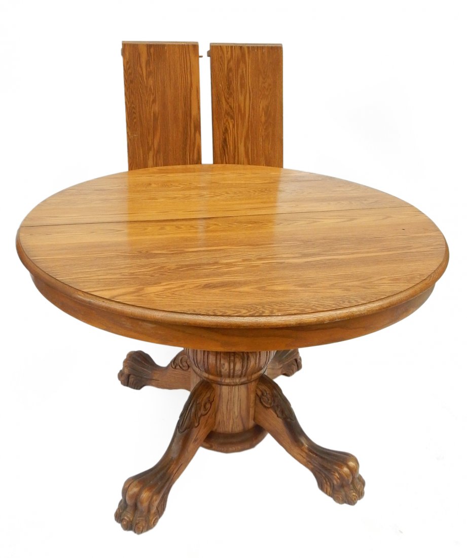 Oak Pedestal Table with Two Leaves: Victorian-style claw foot table with two leaves. [47" Dia x 30 1/4" H; Leaves: 12" each].