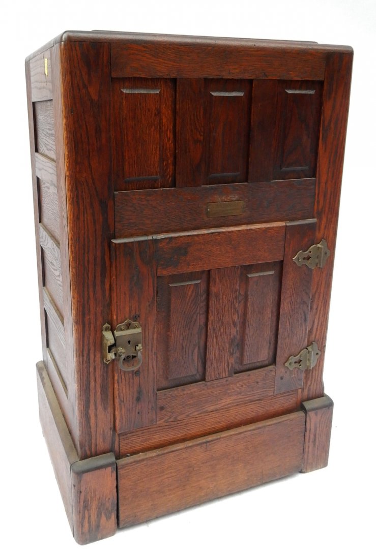 Antique Oak Icebox: Oak paneled icebox with one lower door and a hinged top. Missing handle on top. [22 1/4" L x 16" D x 37" H]. Sold "as is".