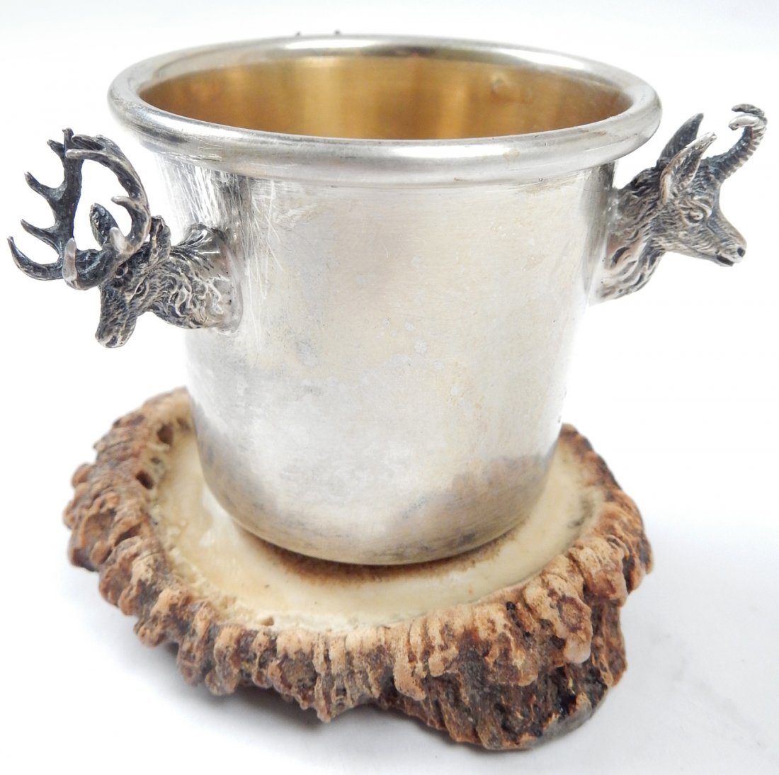 Sterling Silver Cup with Figural Deer: Sterling silver cup mounted on a section of antler with three figural trophy deer, antelope, and mountain goat. Marked "Sterling". [2 3/8" H x 2 3/4" W]. In good condition.
