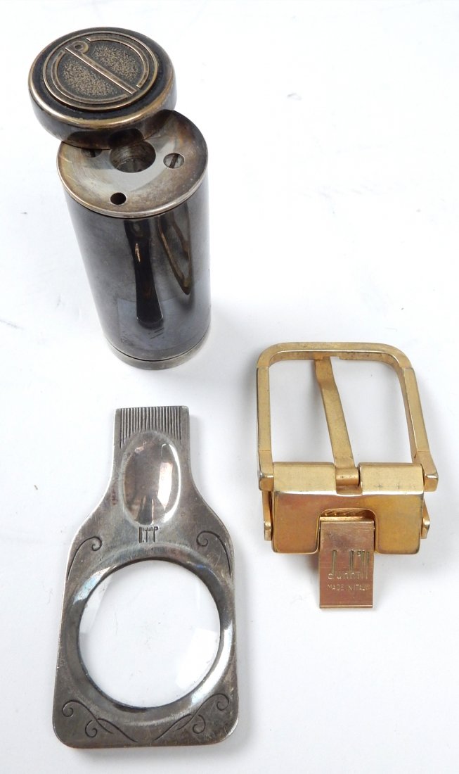 Sterling Magnifier and Assorted Items: Comprises: Small sterling hand magnifier marked "925" with silver plate-encased pencil sharpener [2 3/4" x 1 1/2"] and a Dunhill belt buckle. In good condition.