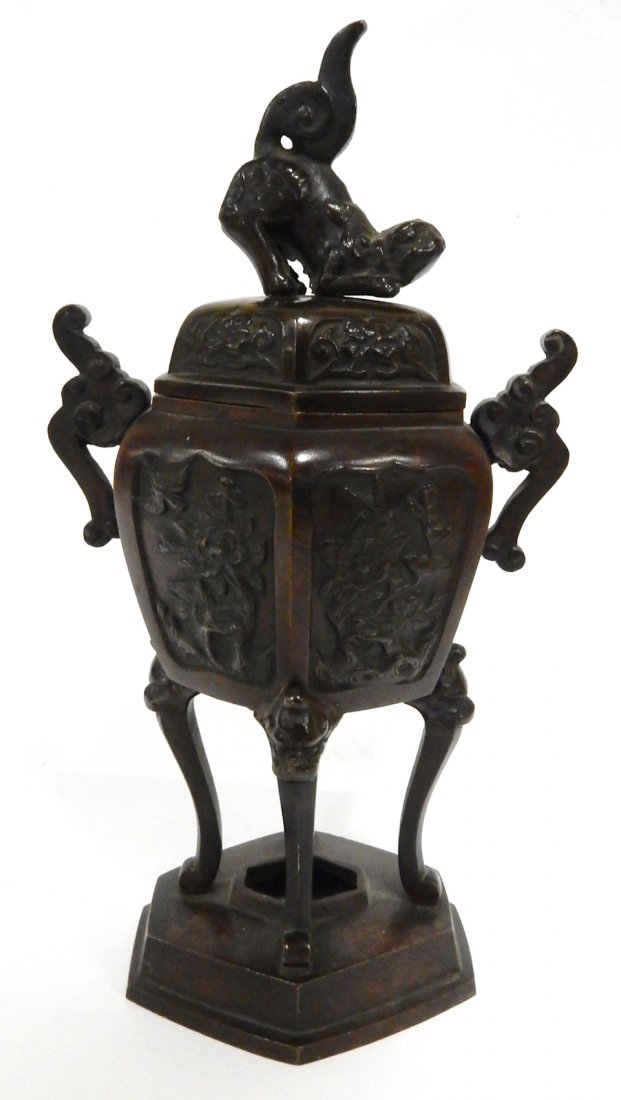Asian Bronze Hexagonal Censer: Asian censer in the form of a hexagonal vase on four legs with foo dog finial. [5 1/2" W x 3 12" D x 10 1/4" H]. Bears light brown patina. From Martin Parker / Spencertown Art and Antique Company.