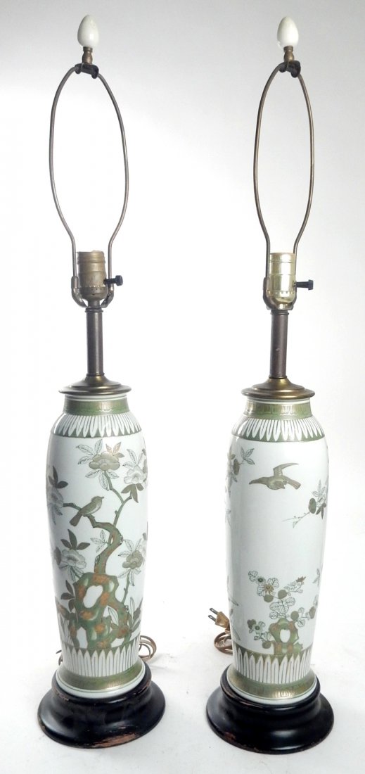 Pair of Asian Porcelain Lamps: Pair of Asian green and gold porcelain vases converted into lamps with ebonized wood bases. [32" H base to finial, 6 1/4" dia]. In good condition.