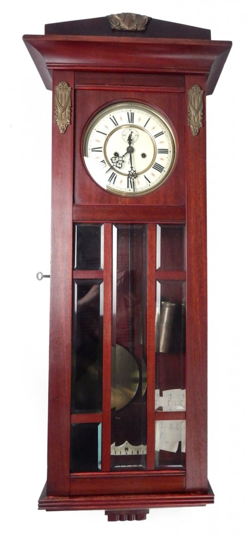 Gustav Becker Regulator Clock: 19th century German-made movement and clock face. Contemporary mahogany and glass case. [14 5/8" x 7 3/8" x 39"]. Left side screen window broken left side ornamentation. Imperfections to wood undersid