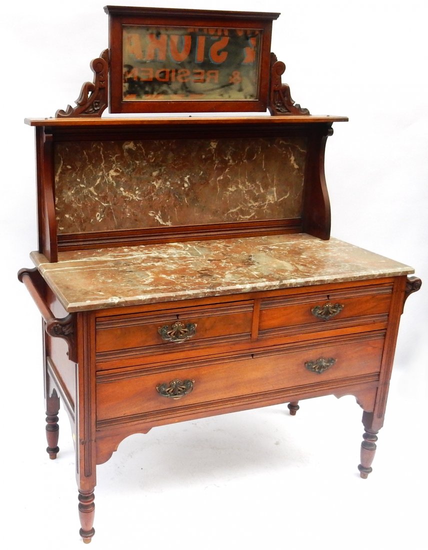Marble Top Mahogany Washstand: Featuring three drawers, marble top, and hanging racks on sides. Back and central apex mirror. [45 1/2" x 19 1/4" x 62 1/2"]. Missing two handles. Some nicks and scratches.