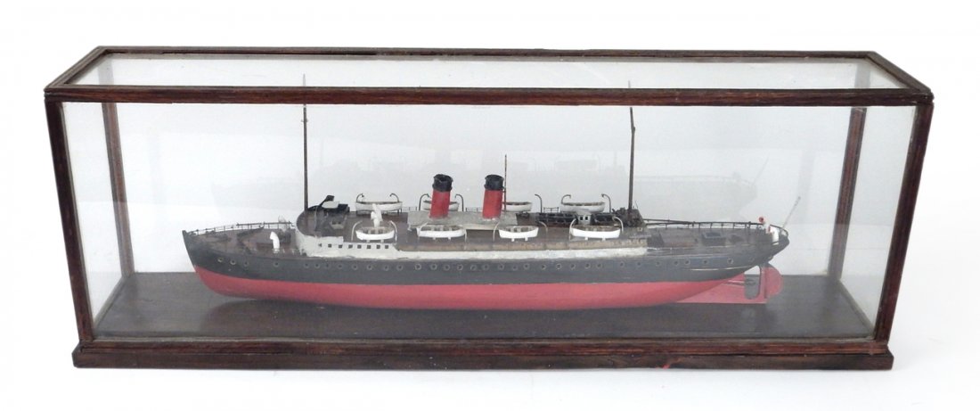 Wood Ship Model in Glass Vitrine: Wooden ship model painted red and black with lifeboats. Wood base with glass vitrine. [29 1/2" L x 5 1/2" W x 10 3/4" H]. Glass cracked on one side.