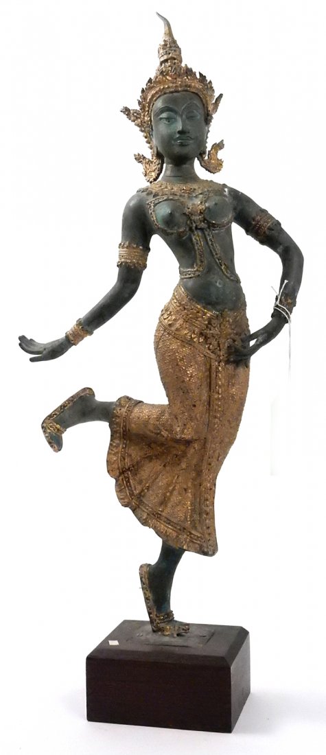 Parcel Gilt Balinese Bronze Deity: Depicts a goddess dancing in an ornate costume with elaborate headdress. Mounted on a wood plinth base. [Bronze only: 12" W x 4" D x 26 1/2" H; on base: 29 1/2" H]. Crack at proper left shoulder. From