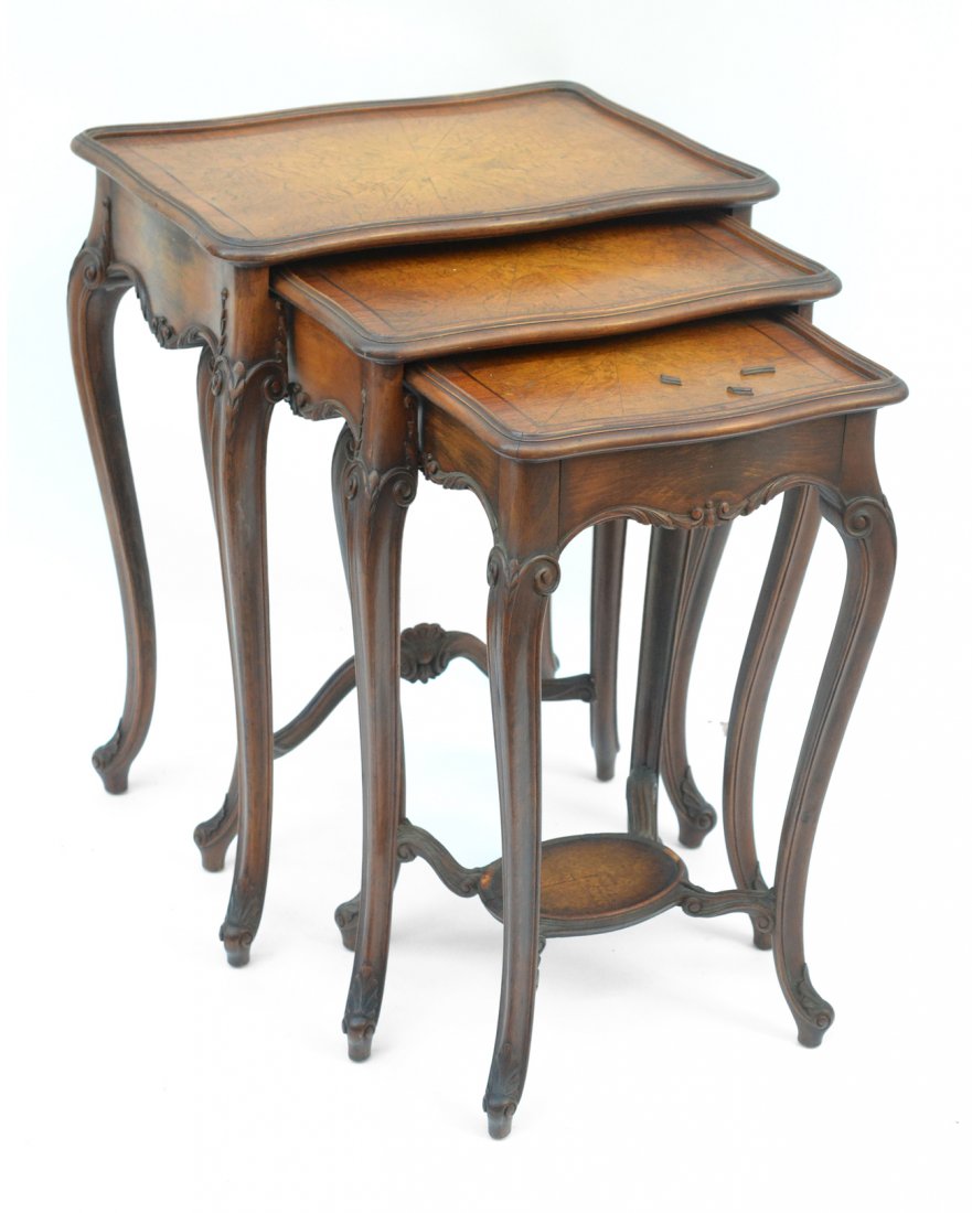 Antique Louis XV Style Nesting Tables: Set of three carved walnut nesting tables with sunburst burlwood parquet tops. [Largest: 21 5/8" W x 27 3/8" H]. Wear with minor veneer tenting and losses to trim.