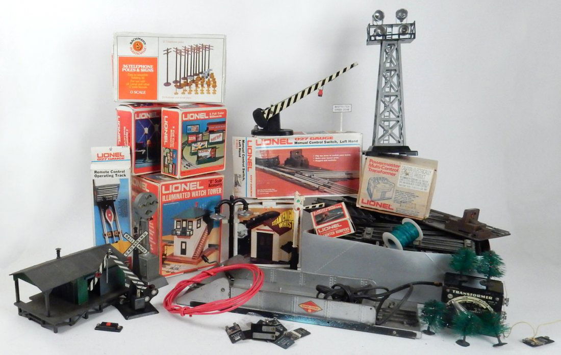 Assorted Lionel Train Accessories: Comprises vintage and modern "0" and "027" gauge accessories including: 1.) 027 track (30+ straight and 90+ curved sections). 2.) Two transformers. 3.) Track signal. 4.) Track lights. 5.) Three buildi