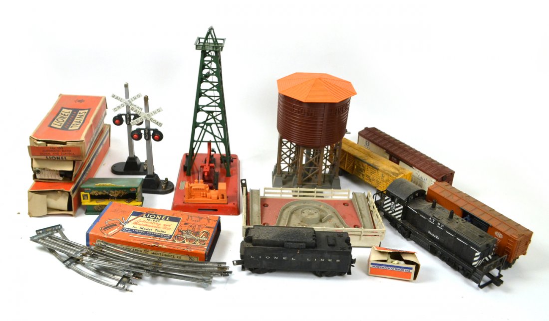 Assorted Vintage Lionel Trains & More: Comprises: 1.) "027" locomotive. 2.) "Diesel Switcher" locomotive. 3.) Coal car. 4.) 11 various cars (circus, tanker, refrigerator, and others). 5.) Water tower. 6.) Oil derrick. 7.) Four assorted rai