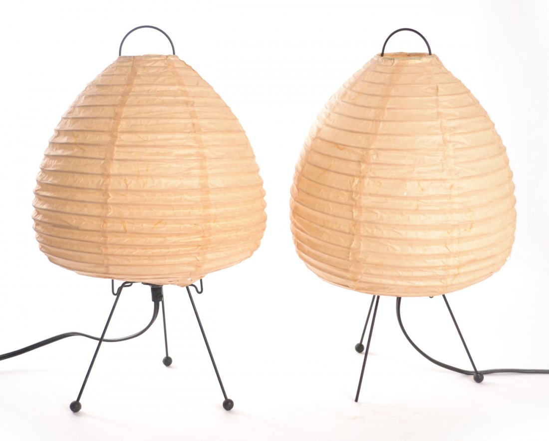 Pair of Naguchi "Akari" Lamps: Black wire, tripod leg lamps with spherical feet. [6 1/2" Dia x 15 3/4" H (to top)]. One lamp missing one foot.