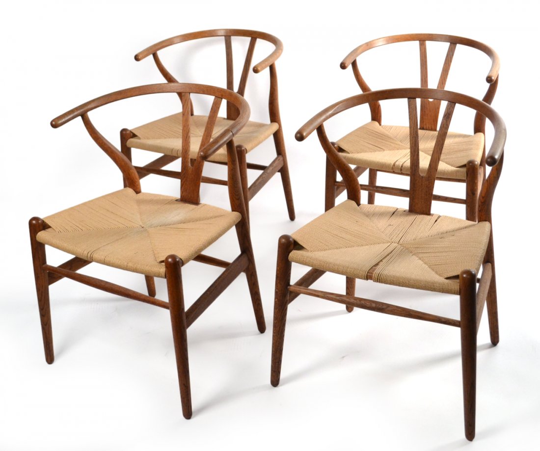 Set of 4 Modern Danish-Style Chairs: Oak chairs with wicker seats. [20 1/2" W x 20 3/4" D x 28 1/2" H]. Damage and previous repair to one chair's left arm.