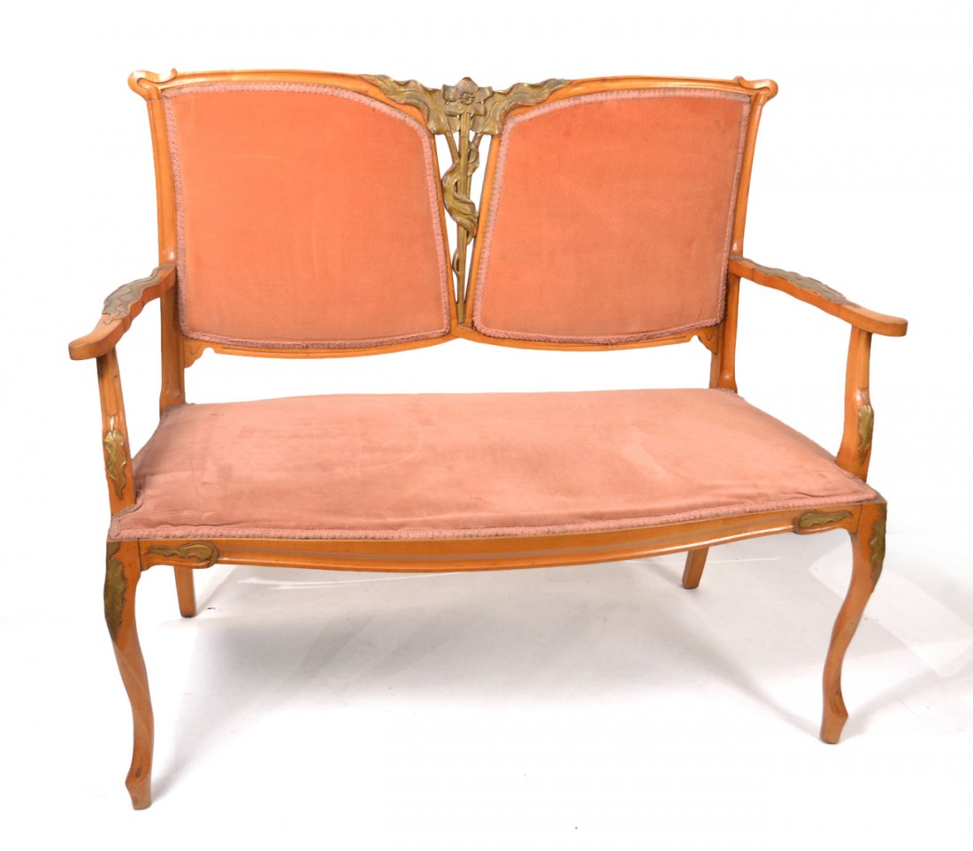 French Art Nouveau Salon Set: French Art Nouveau maple five-piece salon set with painted and carved floral design and pink upholstery (att: Geo. De Feure). [Settee: 49 1/2' W x 23" D x 38" H; Arms: 24" W x 22" D x 38 1/2" H).