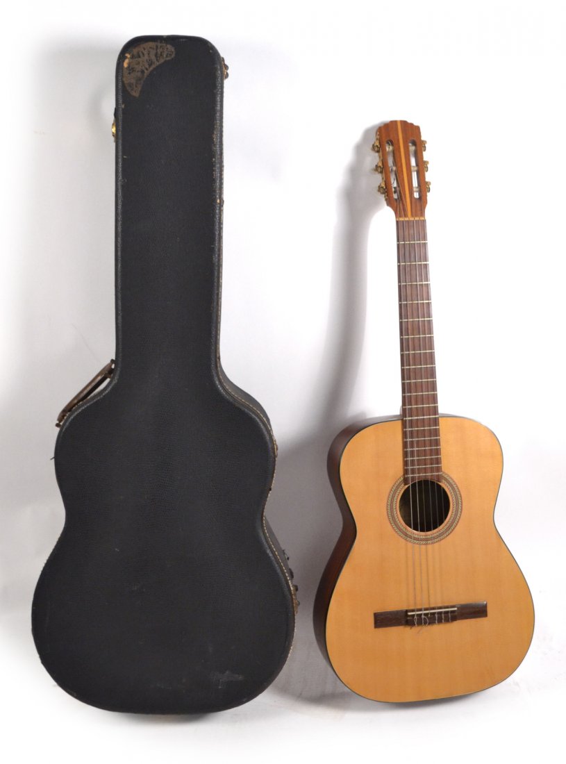 Goya Six String Guitar and Case: Manufactured by A.B. Herman Carlson Levin, case included. [14" W x 3 3/4" D x 37" H]. Surface cracks to back of body, nicks throughout.