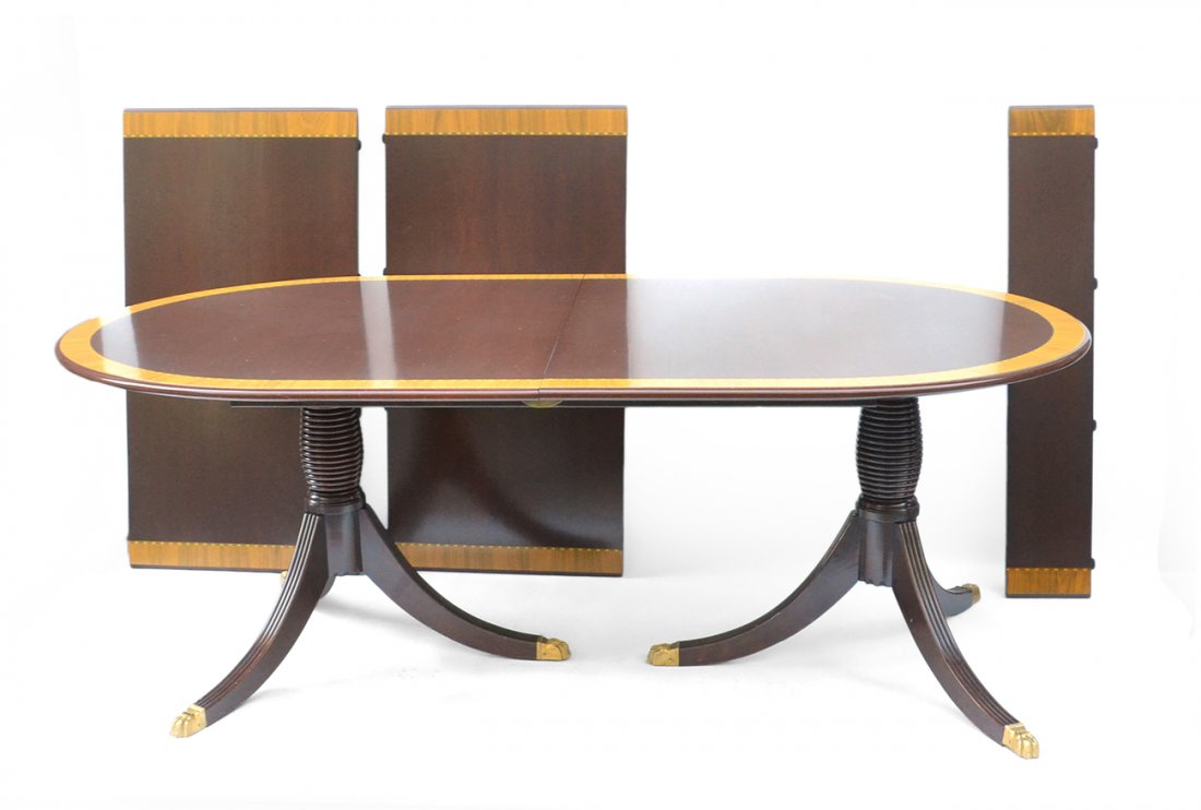 Sheraton-Style Dining Table: Double pedestal tripod base mahogany dining table with lion paw feet, banded inlay and three leaves. [Closed: 84 1/2" W x 46 3/4" Deep; two leaves are 24" W, one leaf is 8" wide]. Scuffs and scratches