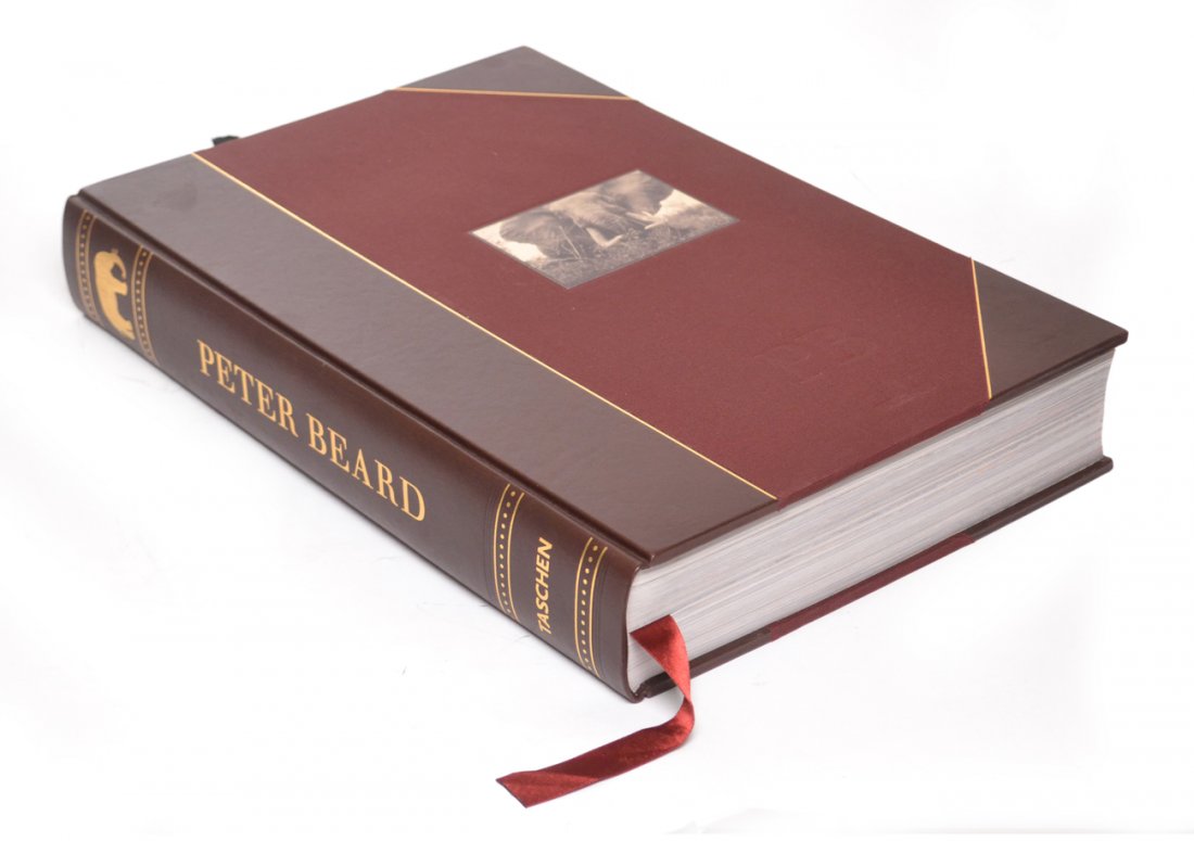 Peter Beard, Signed Folio Photo Book: Art edition. Benedikt Taschen, Koln, Germany, 2006. First edition limited to 2,500 signed by Beard, of which this is number 1107. Boldly signed and illustrated on frost mylar end page "Peter Beart / M