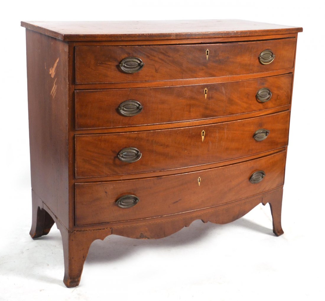 Hepplewhite Mahogany Bow Front Chest: Having four drawers. [41 1/4" W x 21 1/4" D x 36 1/2" H]. Leg broken. Side panel warped.