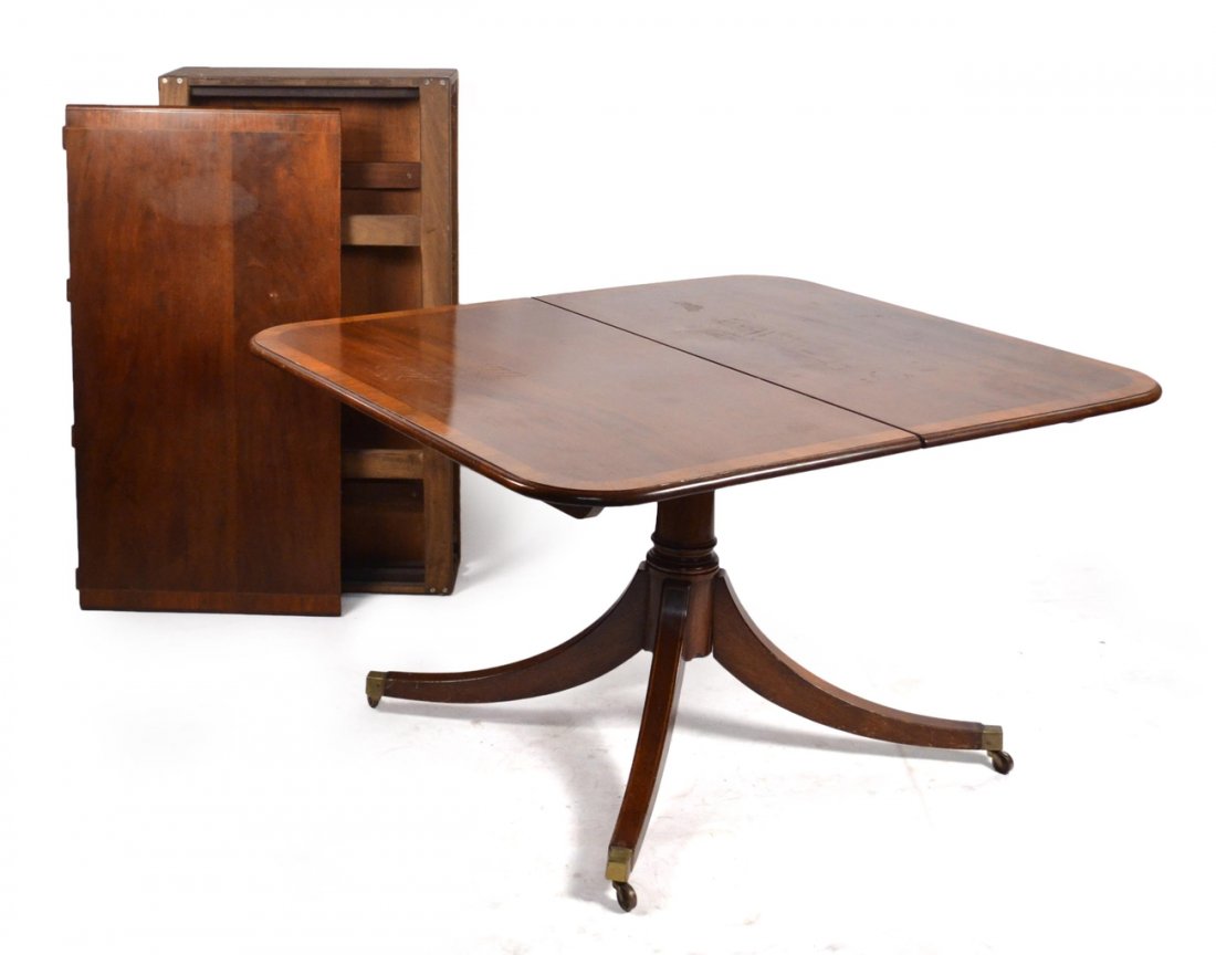 Sheraton Style Dining Room Table: Mahogany banded single pedestal table with three leaves. [50" W x 41 1/2" D x 28 1/2" H]. Two 23" leaves, One 20" leaf. Scratches. Wear consistent with age.
