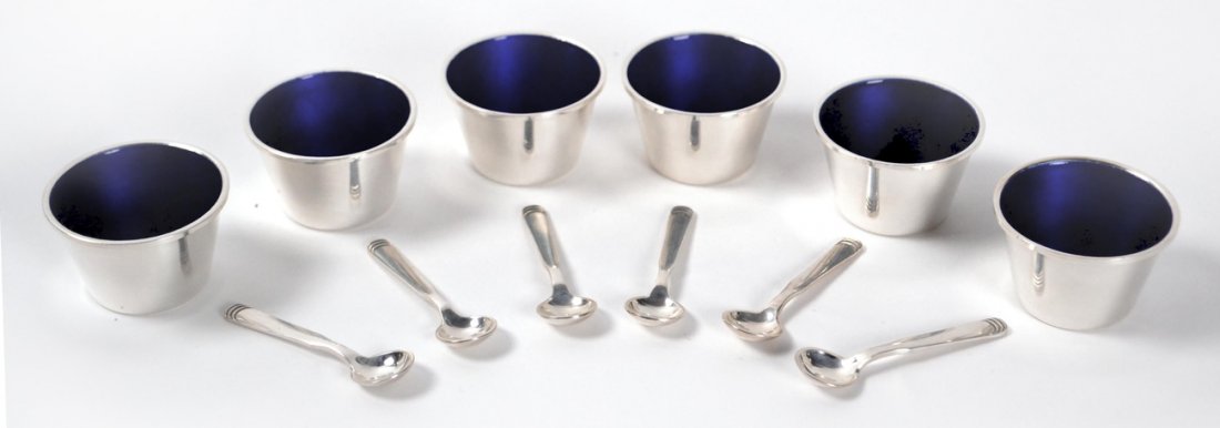 Six Sterling Hans Hansen Salts: Danish mid-century modern open salt cellars with blue enamel interiors. Each marked on bottom "Anno 1953/Hans Hansen/Denmark/Sterling/390". [1 7/8" Dia x 1 1/4" H]. Accompanied by six Hans Hansen salt