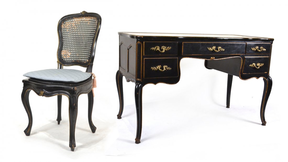 French-Style Ebonized Desk with Chair: Louis XV-style ebonized desk with a creme tooled leather top, together with a black caned side chair. [48" L x 24" D x 30" H; 23" H floor to apron of kneehole]. Each worn, seat damaged.