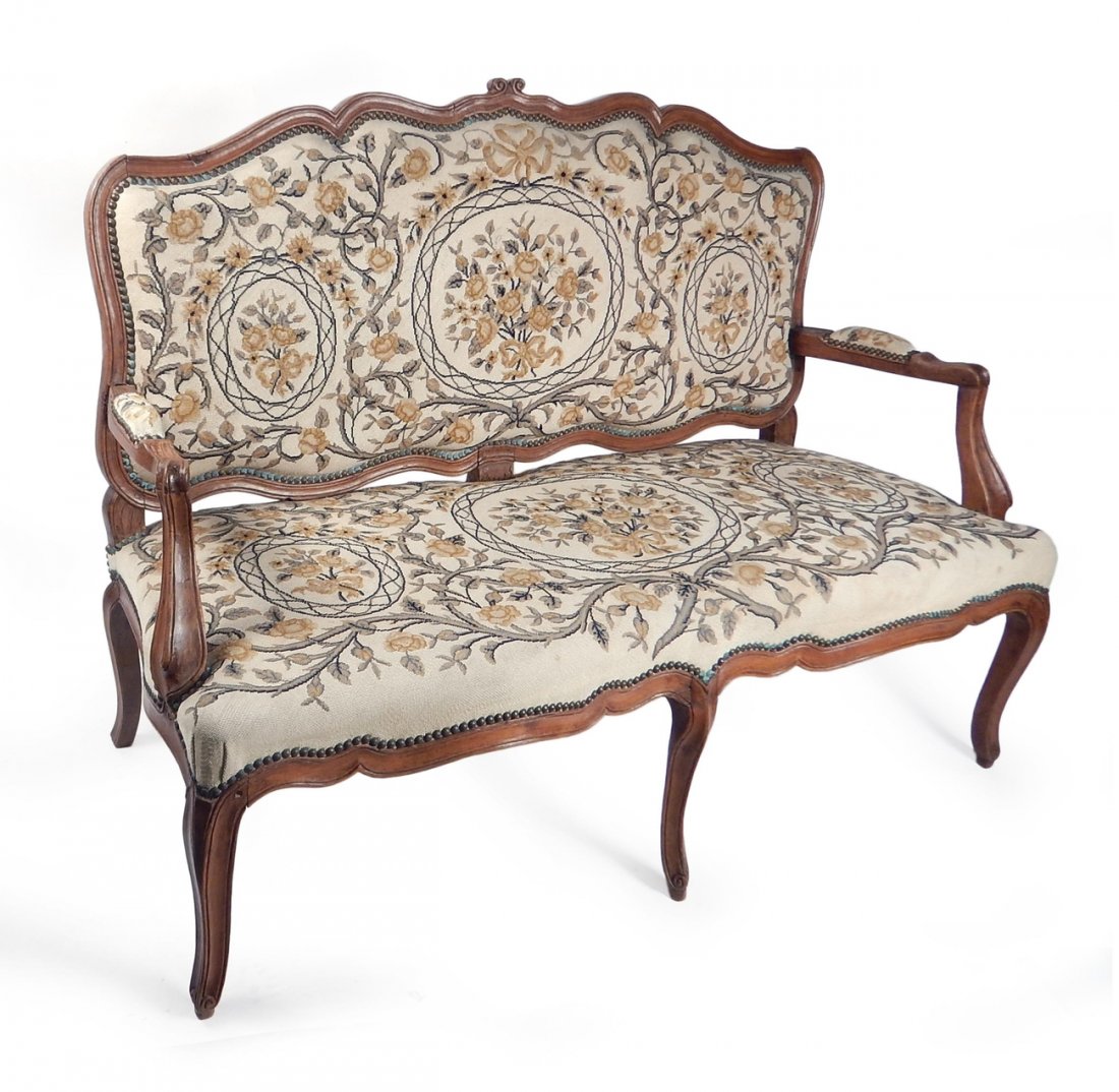 Antique Italian Floral Settee: Antique walnut settee with floral needlepoint upholstery. [54" W x 22" D x 38 1/2" H; 16 1/2" to seat]. In overall good condition.
