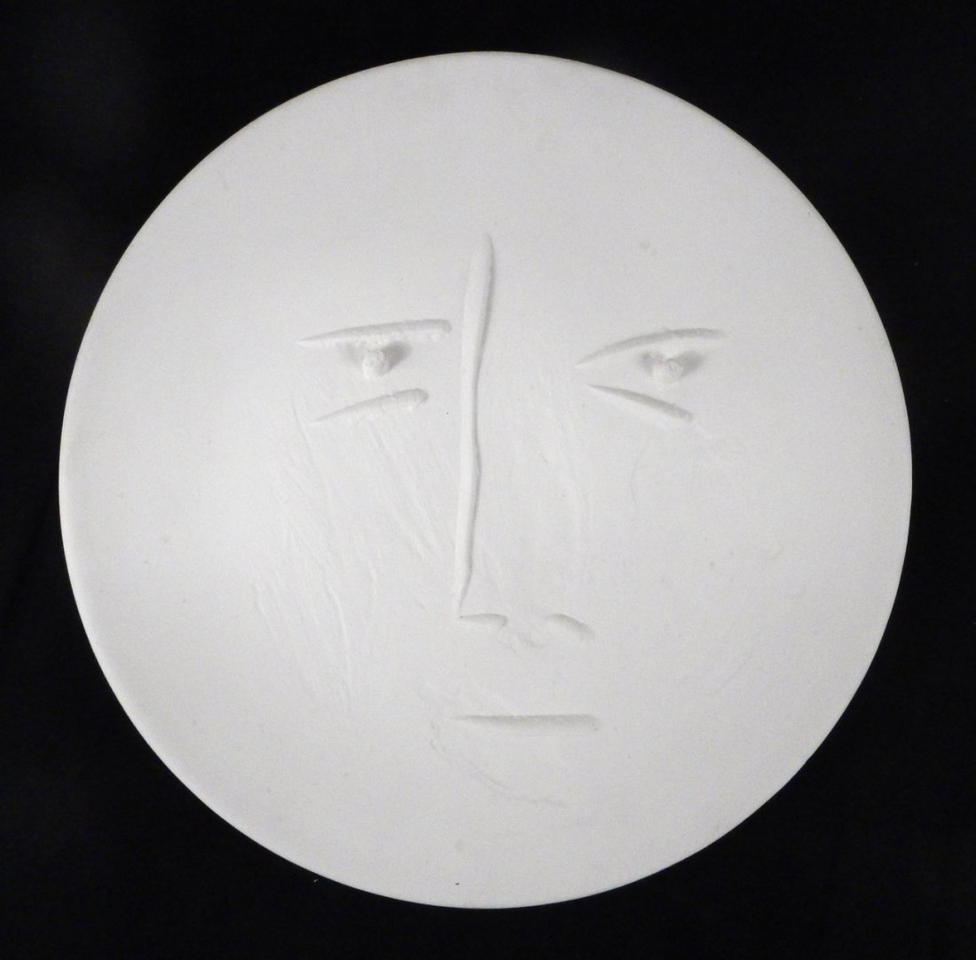P. Picasso, "Visage de Face", Charger: White ceramic charger, circa 1960. Bears impressed stamps on bottom "Madoura / Plein Feu" and "Empreinte Originale de Picasso". With incised marks "U100 / 47 / 100 / Madoura" against a black glazed re