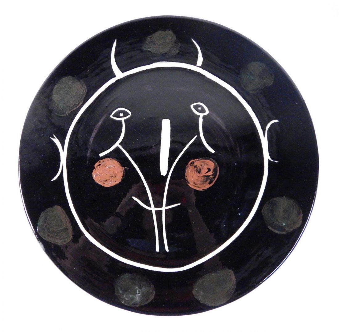 P. Picasso "Service Visage Noir" Charger: Glazed earthenware charge. Circa 1948. Bears impressed stamps on bottom "Madoura / Plein Feu" and "D'Apres Picasso" with painted cypher "CR". [16 7/8" Dia x 1" H]. Wear at edges and crazing on bottom.
